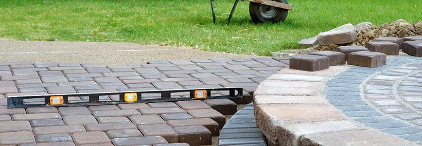 Pflasterarbeiten auf einer Terrasse mit Wasserwaage