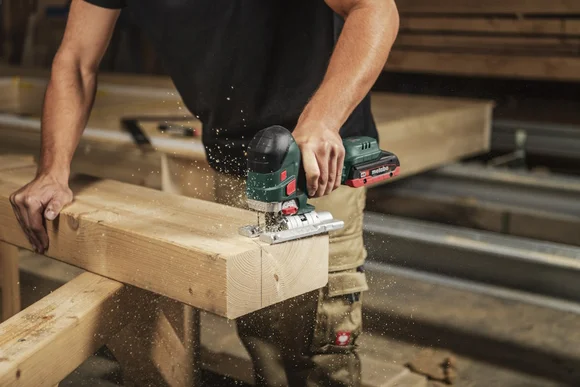 Person sägt Holz mit Stichsäge
