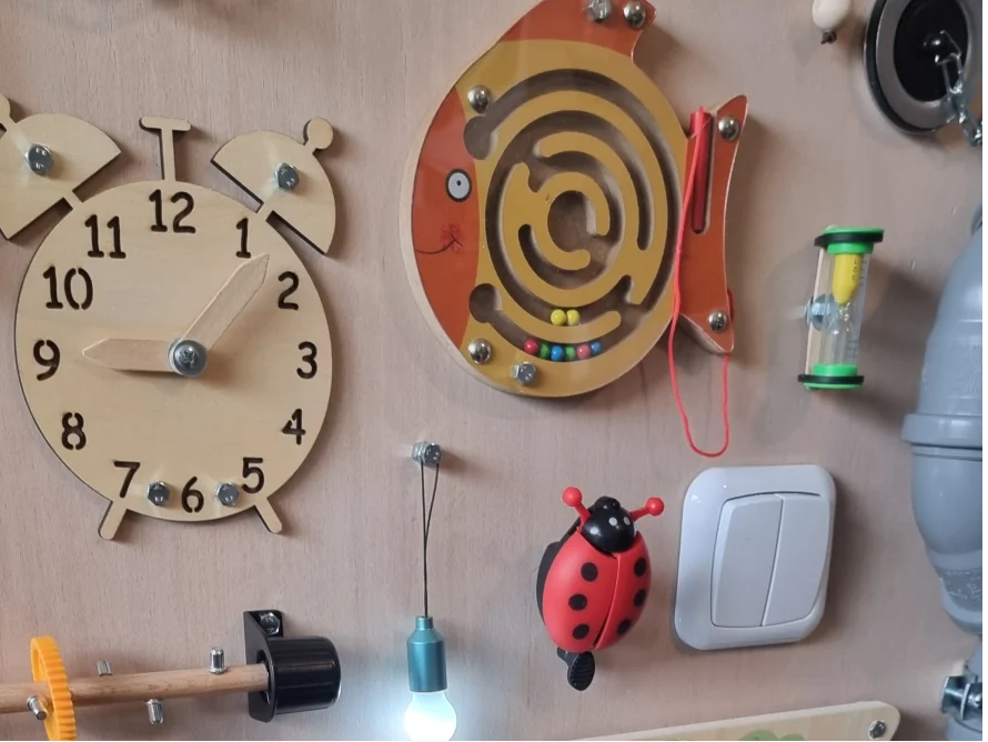 Ein Spielbrett für Kleinkinder mit verschiedenen Aktivitäten.